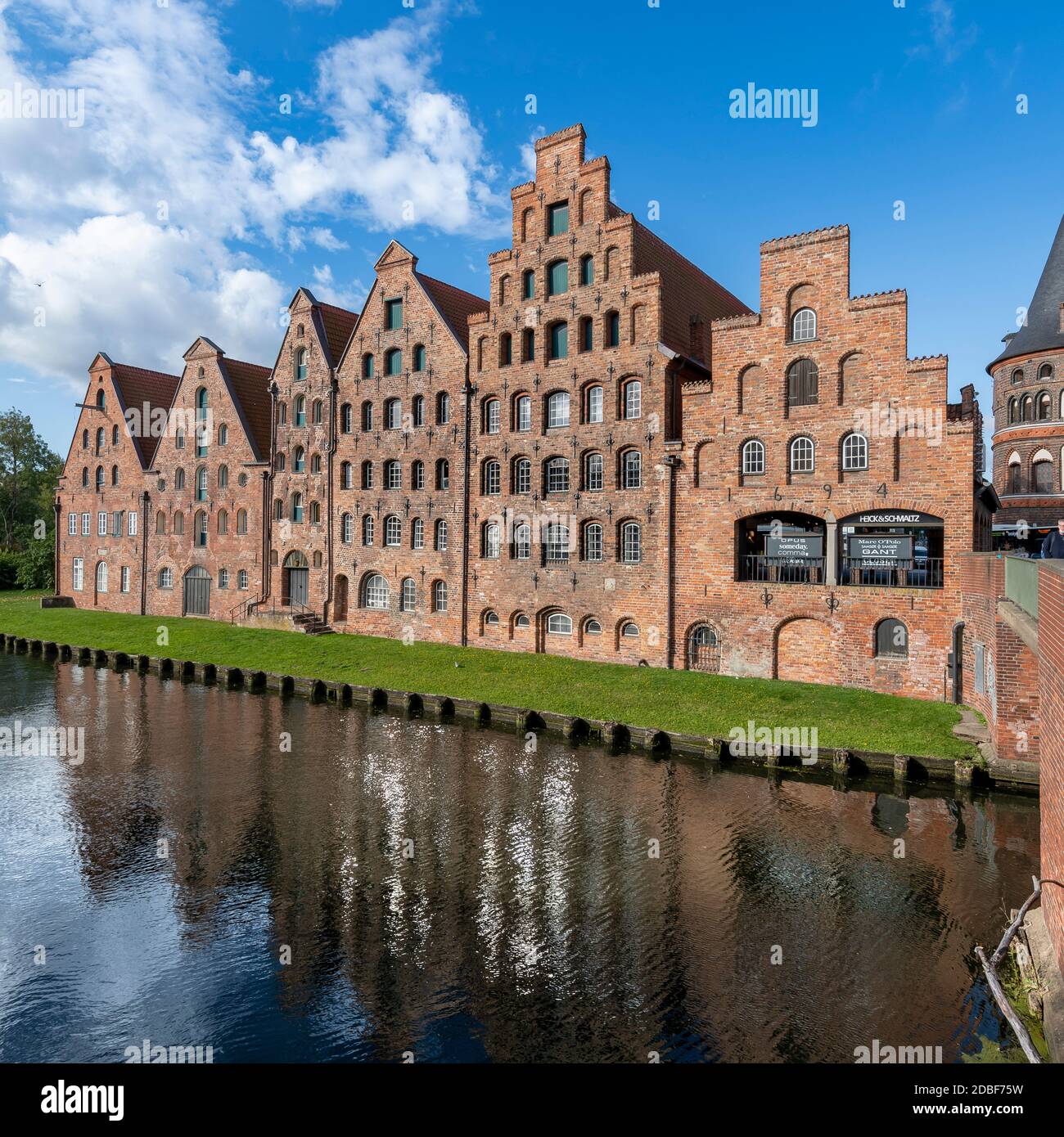 The Salzspeicher (salt storehouses), in Lübeck, northern Germany. Six historic brick buildings on the Upper Trave River next to the Holstentor. Stock Photo