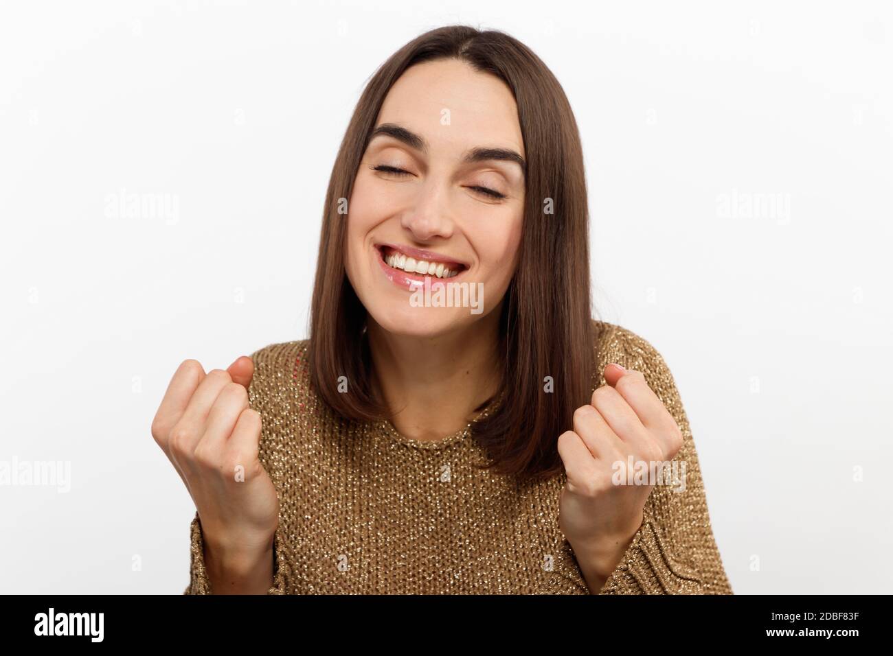 Cheerful happy young beautiful girl looking at camera smiling laughing over white background. Stock Photo