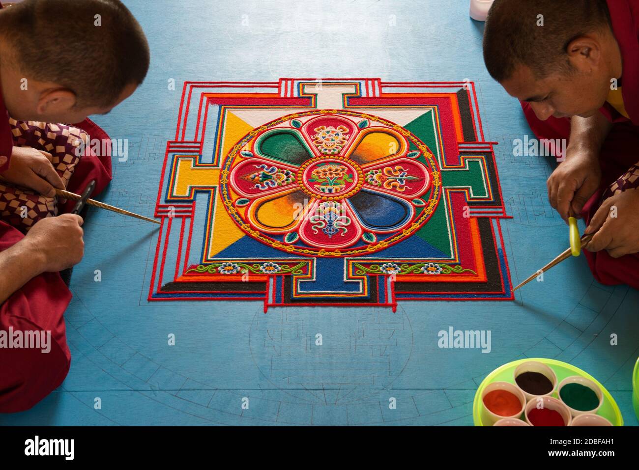 Auroville, India - February 2019: 4 Monks of the Tashi Lumpo Monastery in Tibet creating the Mandala of Compassion in Auroville. Stock Photo