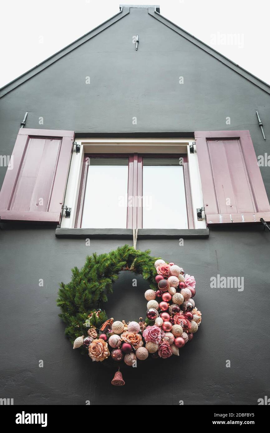 Christmas wreath hanging under a window of a house somewhere in The Netherlands Stock Photo