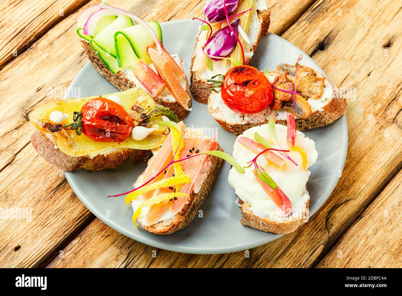 Set of delicious Italian bruschettas with grilled vegetables. Stock Photo