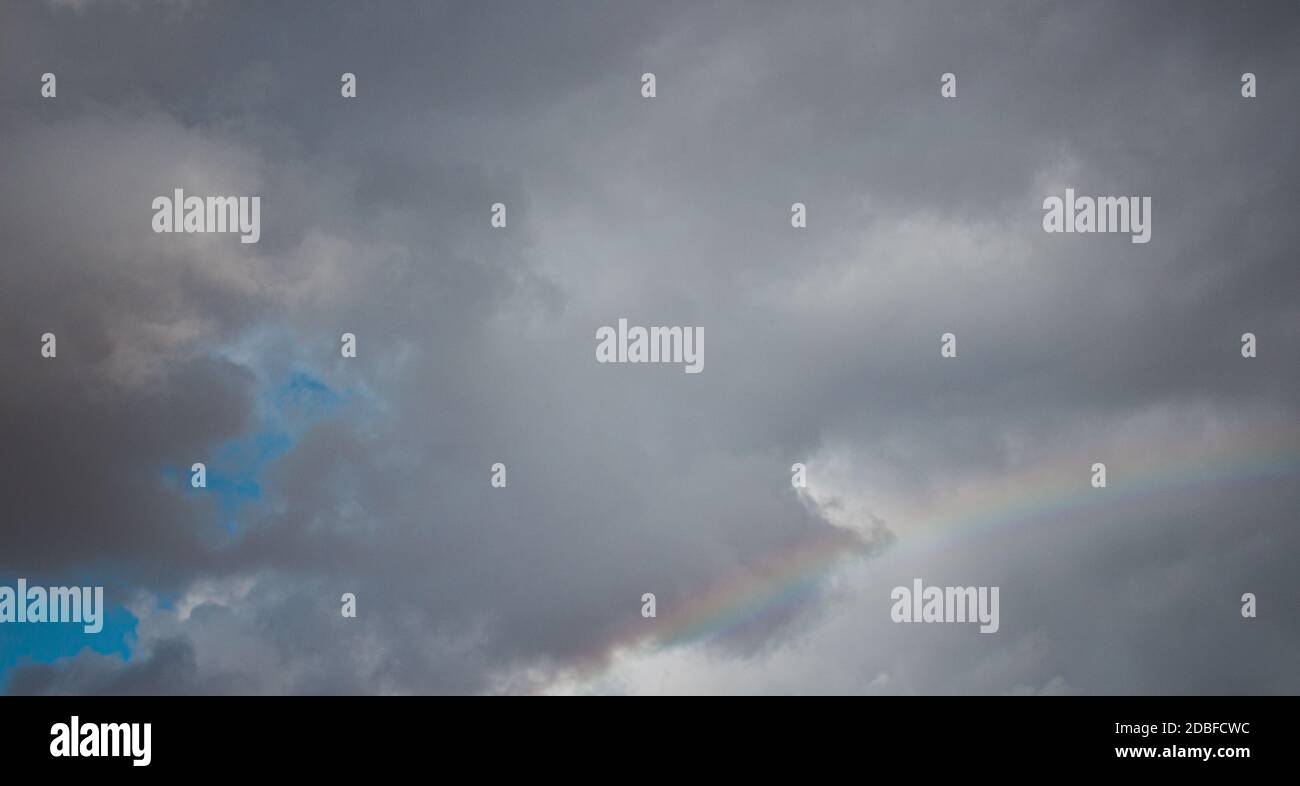Rainbow clouds rain sun blue sky hi-res stock photography and images ...