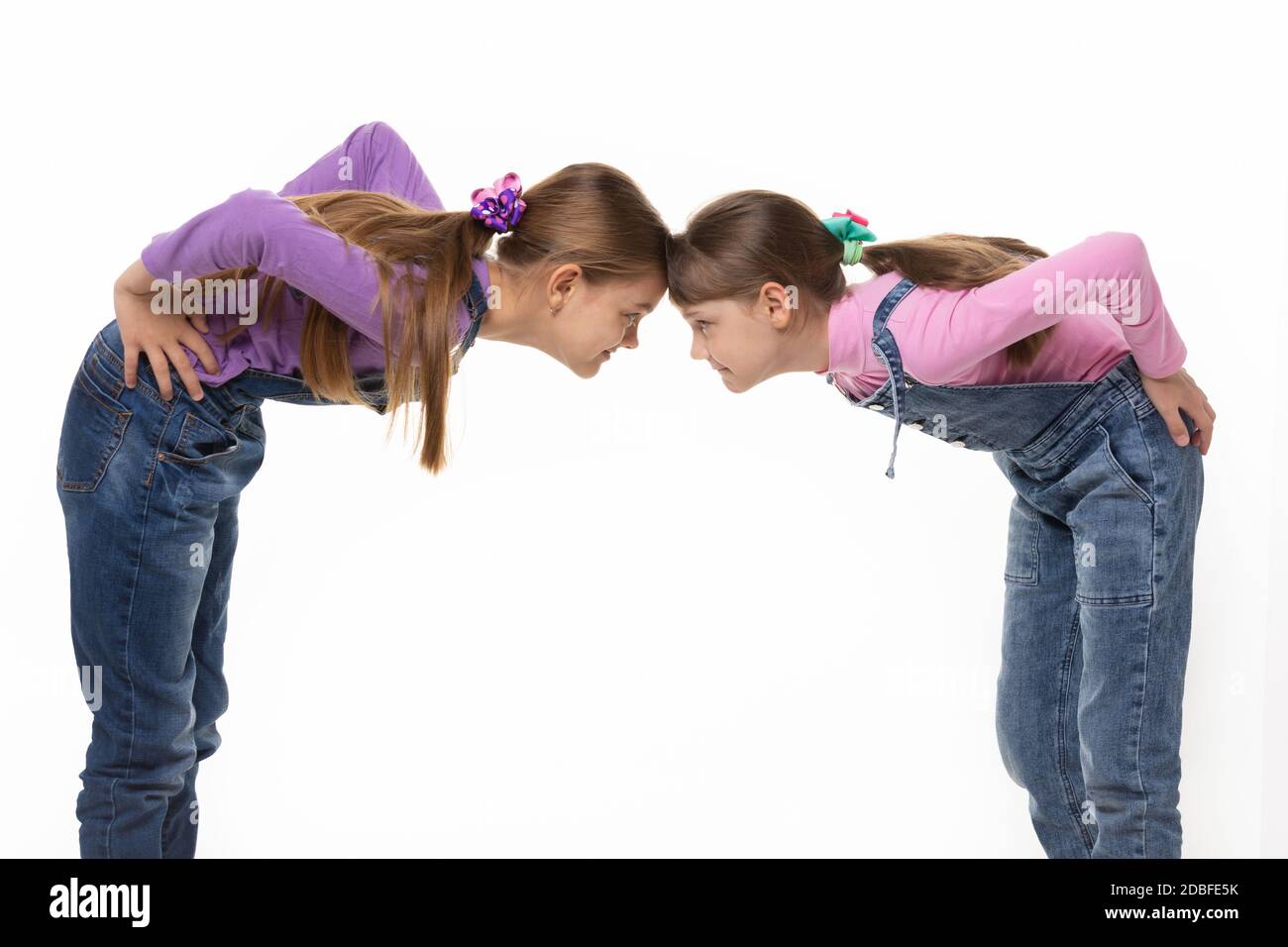 Forehead Rests Against Another quarrel two girls standing leaning their foreheads against to each ...