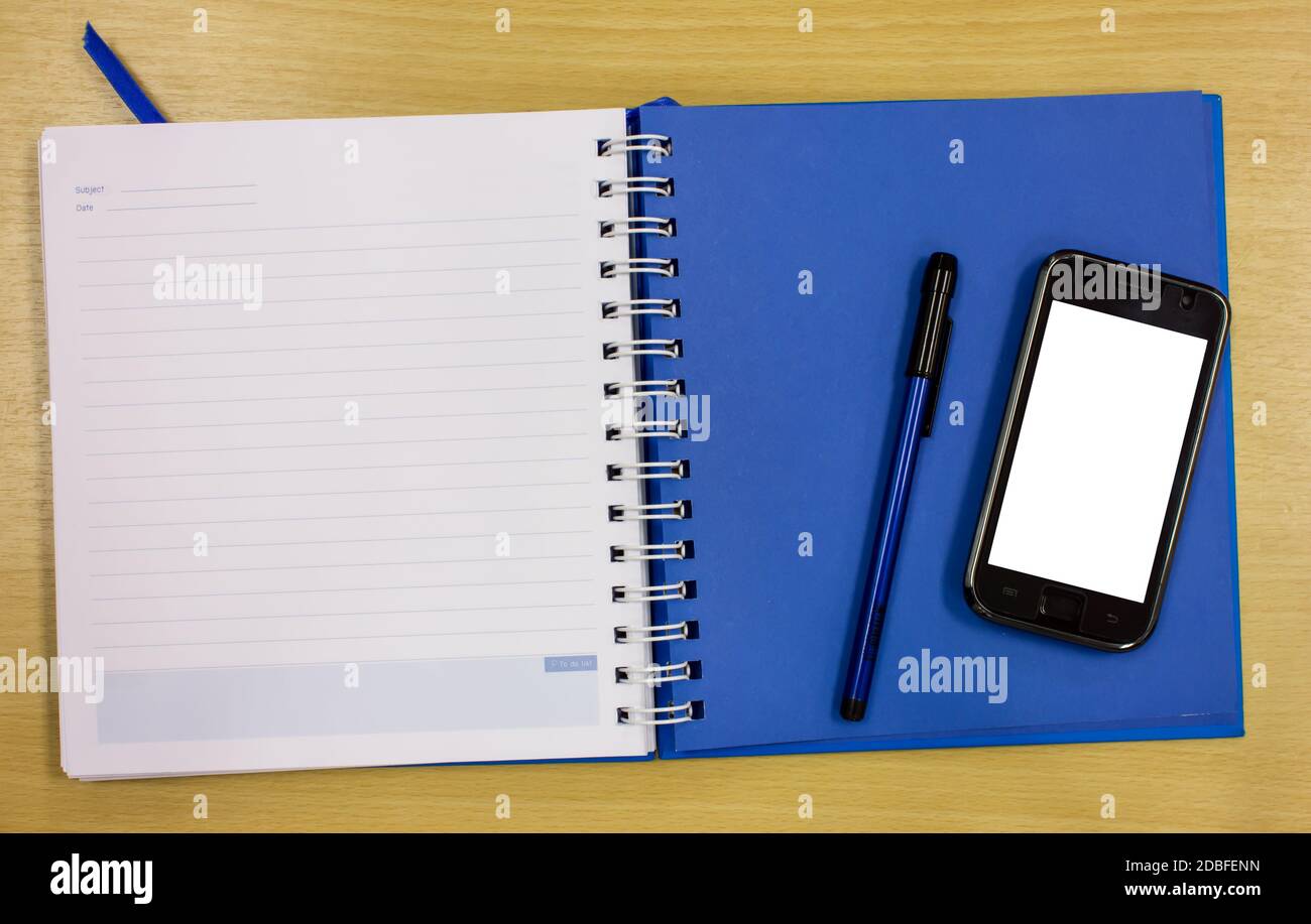 mobile phone blue diary book on table office Stock Photo Alamy