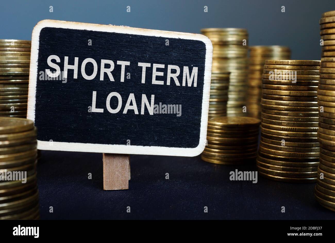 Short term loan inscription and stack of coins Stock Photo - Alamy