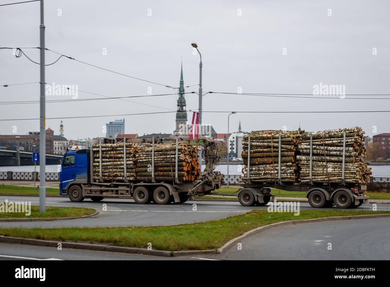 RIGA, LATVIA. 12th November 2020. Truck loaded full of timber driving on the street. Stock Photo