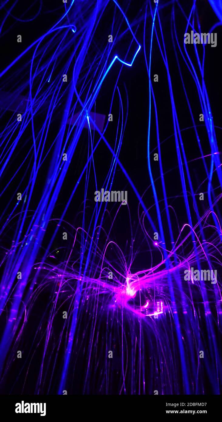 Overlaying wavy lines forming an abstract pattern on a dark background. Stock Photo