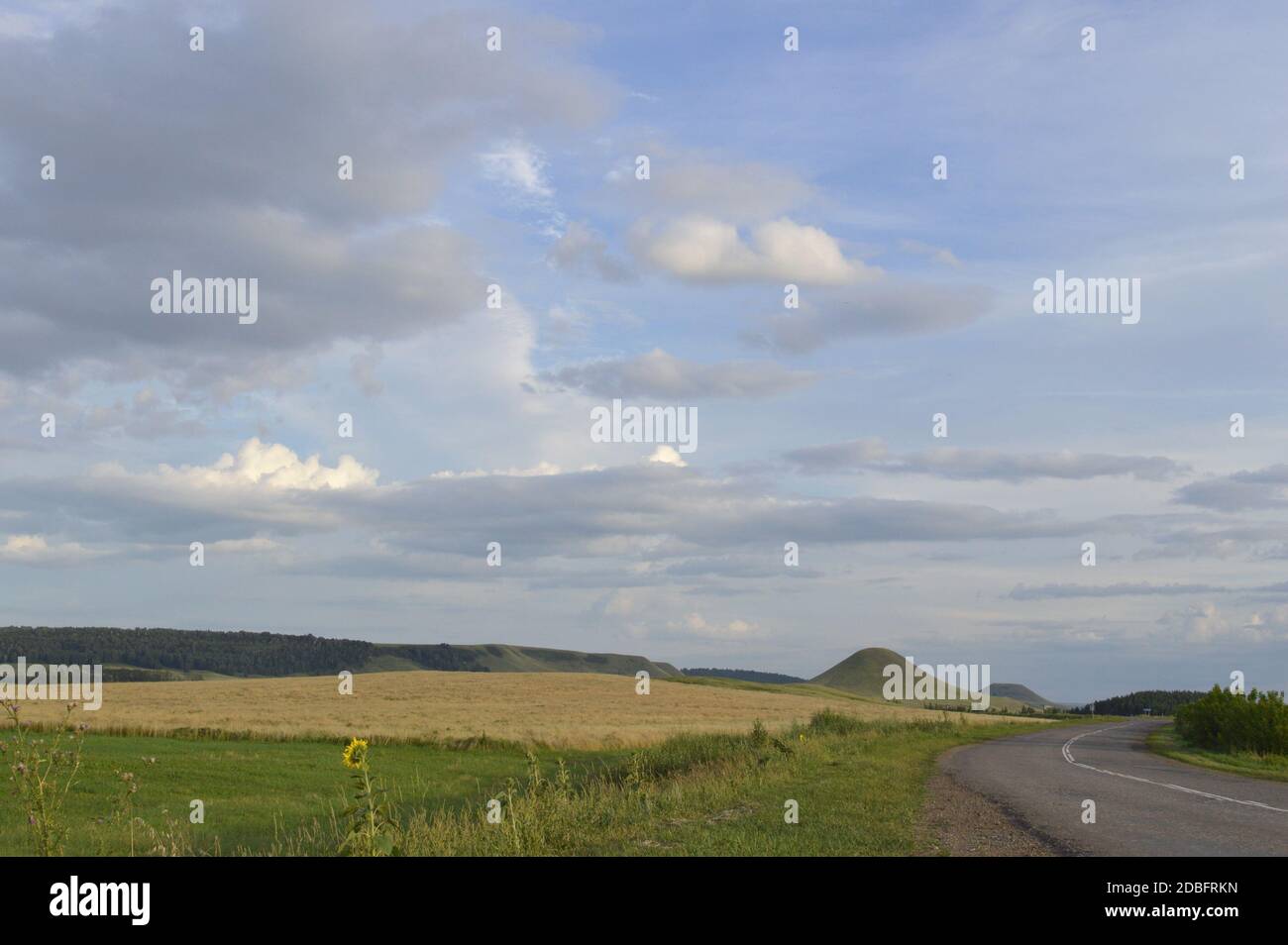 summer landscape with road, mountain and blue sky with clouds Stock ...