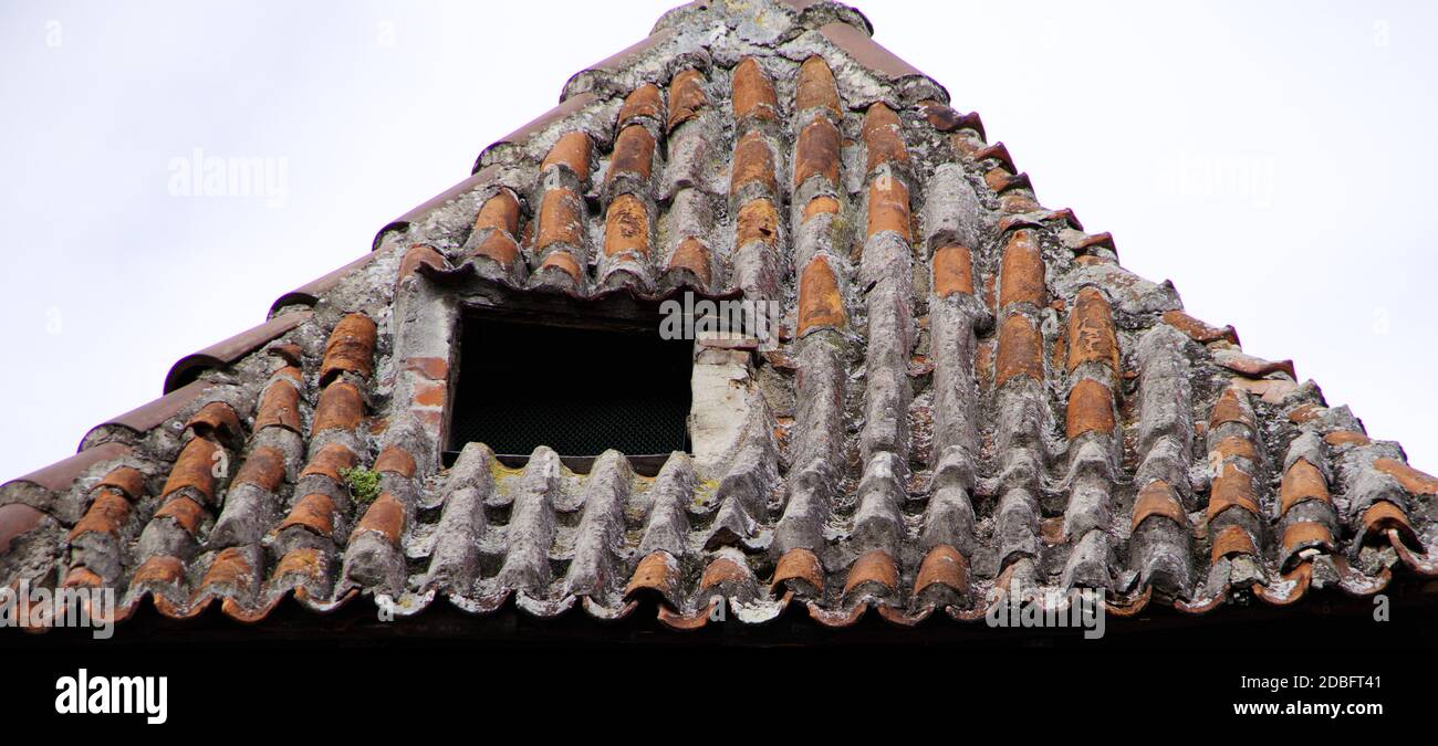 ancient tiled roof of a medieval house Stock Photo