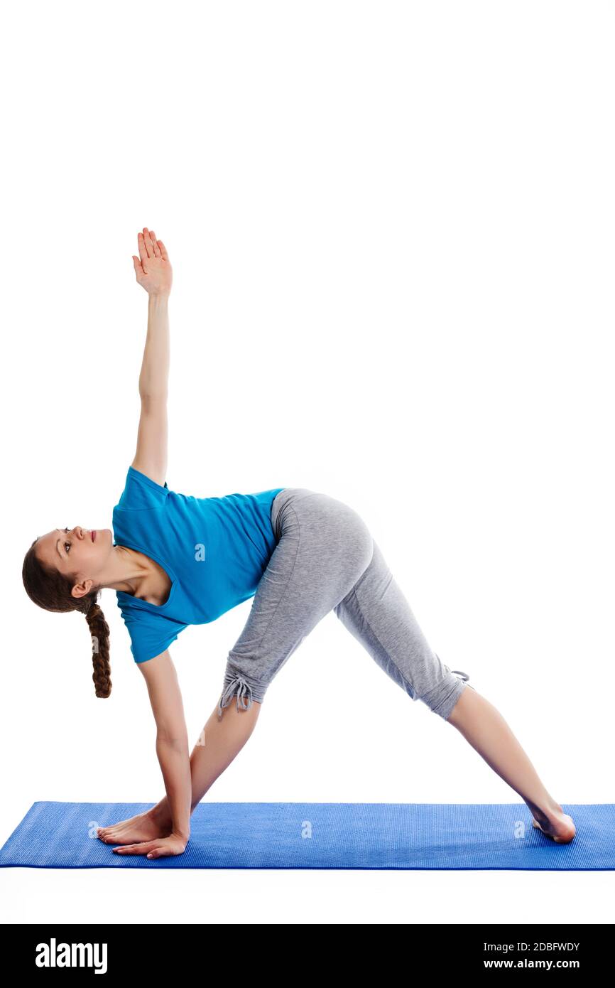 Yoga - young beautiful woman  yoga instructor doing Revolved Triangle asana pose (Parivrtta Trikonasana) exercise isolated on white background Stock Photo