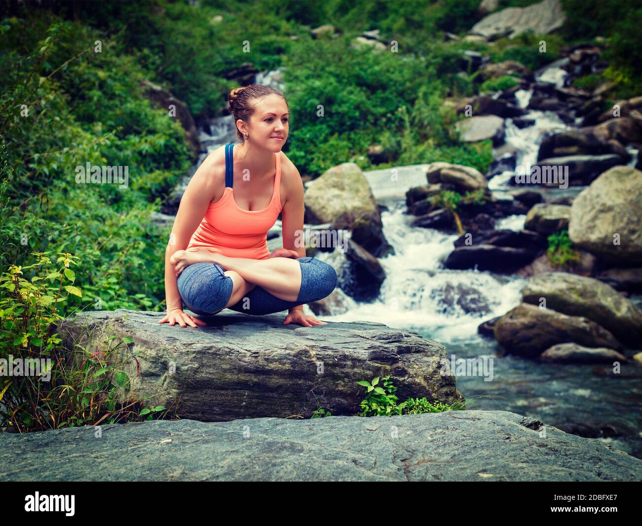 Yoga exercise outdoors woman doing Ashtanga Vinyasa Yoga arm balance