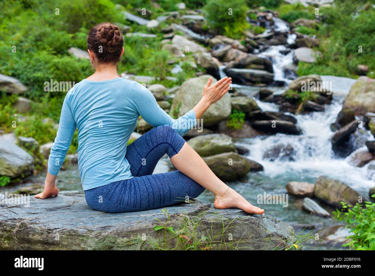 Yoga exercise outdoors - woman doing Ardha matsyendrasanaasana asana ...