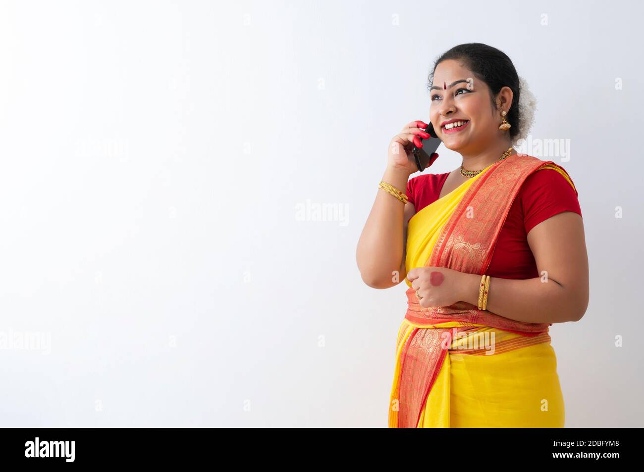 Kuchipudi dancer smiling while talking on call Stock Photo