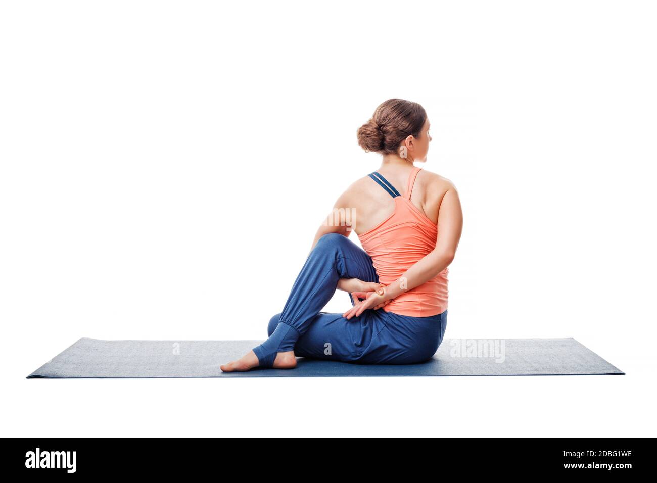 Beautiful sporty fit woman practices yoga asana  Ardha matsyendrasana - half spinal twist pose isolated on white Stock Photo