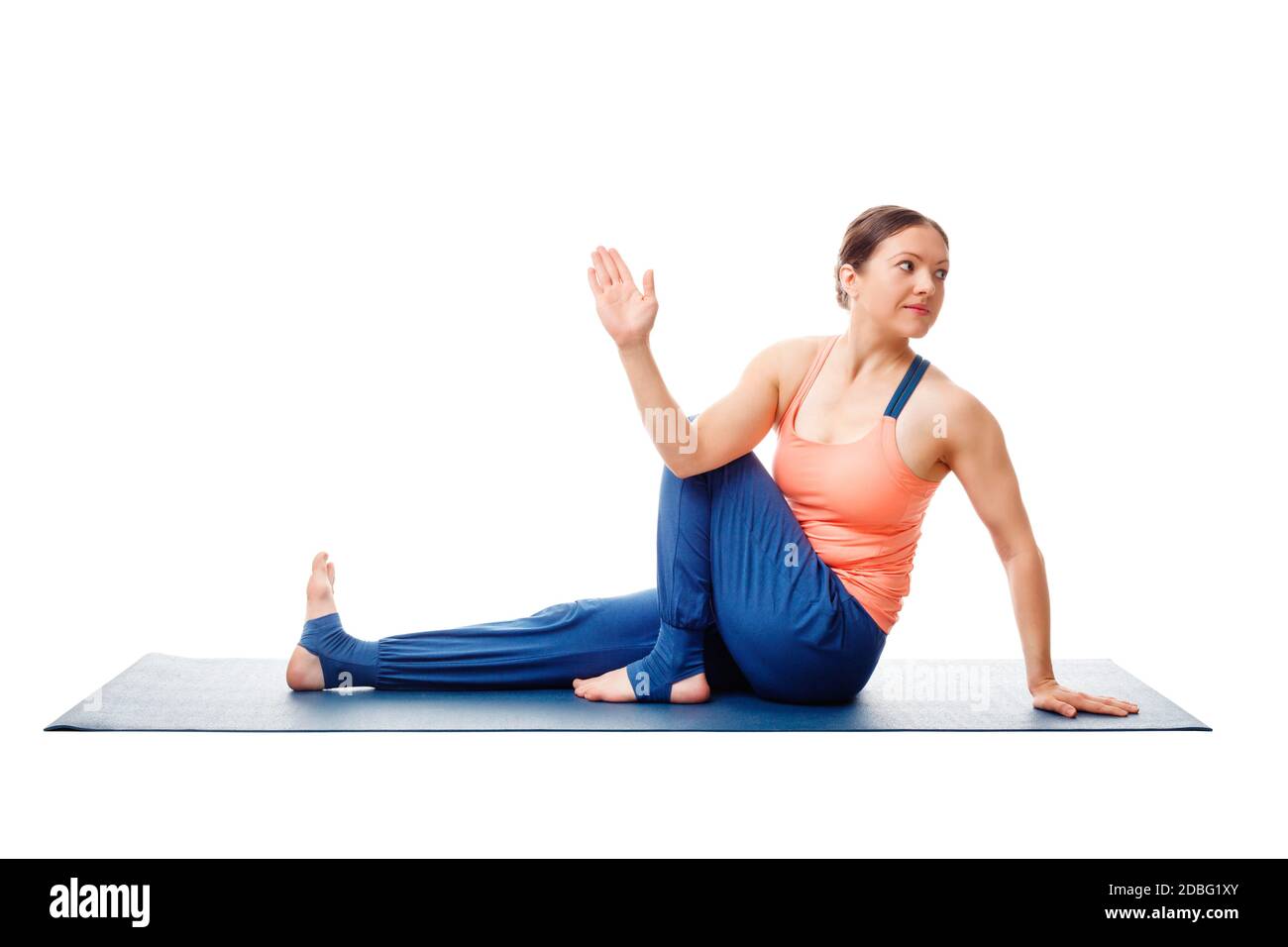 Woman doing yoga asana Ardha matsyendrasana - half spinal twist pose posture isolated on white background Stock Photo