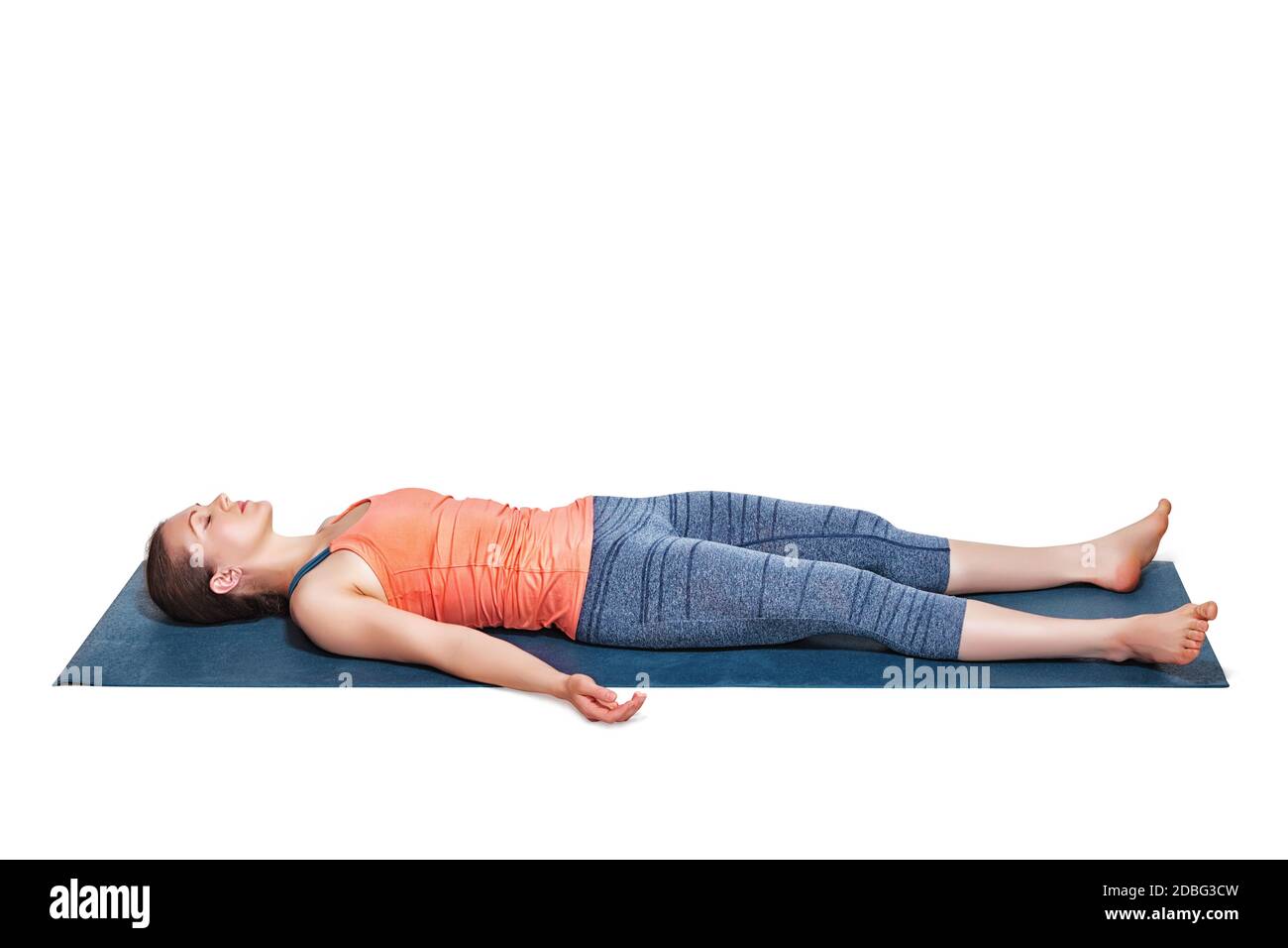 Beautiful sporty fit woman relaxes in yoga asana Savasana - corpse pose ...