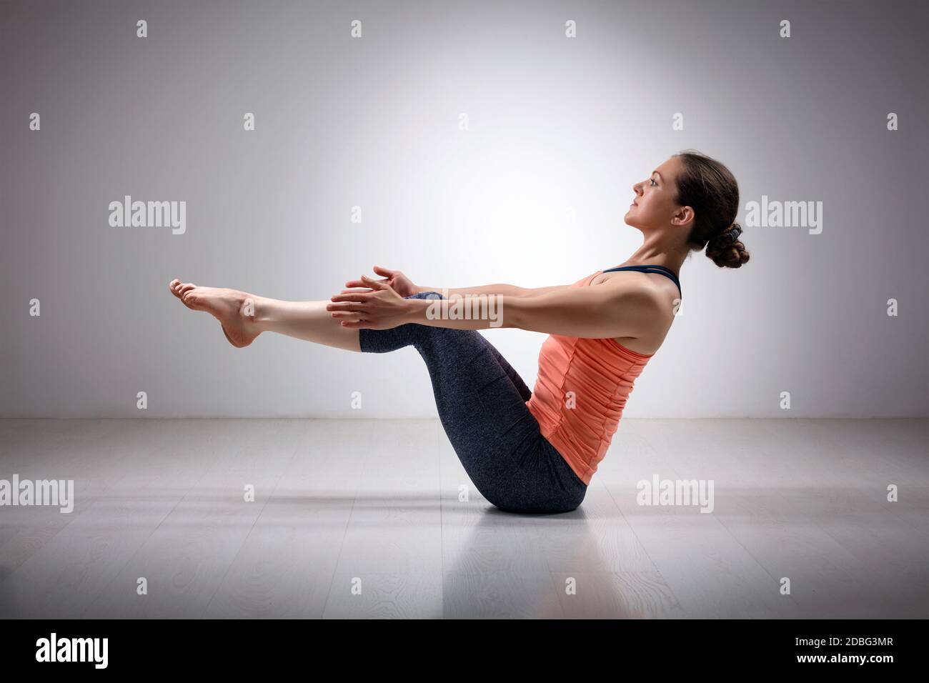 Beautiful sporty fit yogini woman practices yoga asana Paripurna navasana -  boat pose beginner variation Stock Photo - Alamy, image size:1300x956