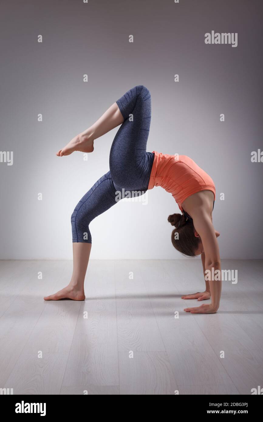 Beautiful sporty fit yogini woman practices yoga asana eka pada
