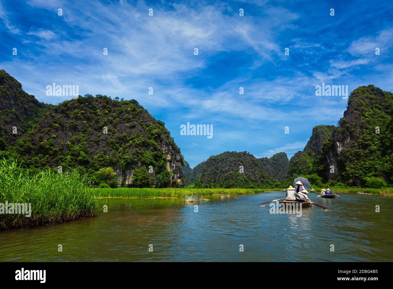 Tourists on boats in Tam Coc-Bich Dong Ngo Dong river in popular tourist destination near Ninh Binh, Vietnam Stock Photo