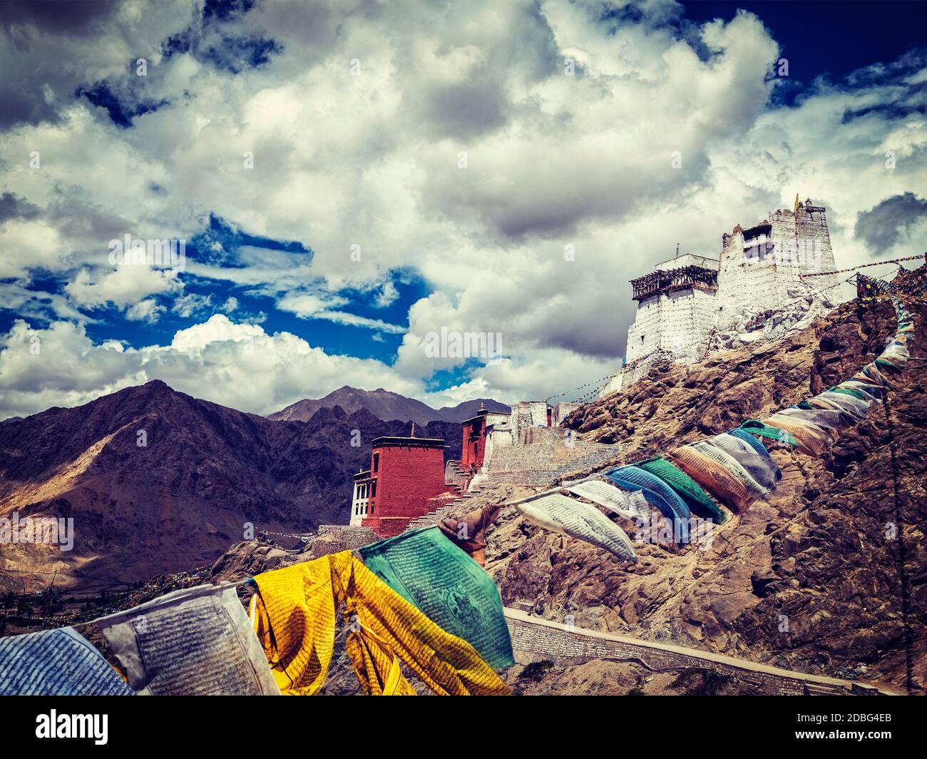 Vintage retro effect filtered hipster style image of Leh Tsemo fort and gompa and lungta (prayer flags) flying in the wind. Leh, Ladakh, Jammu and Kas Stock Photo