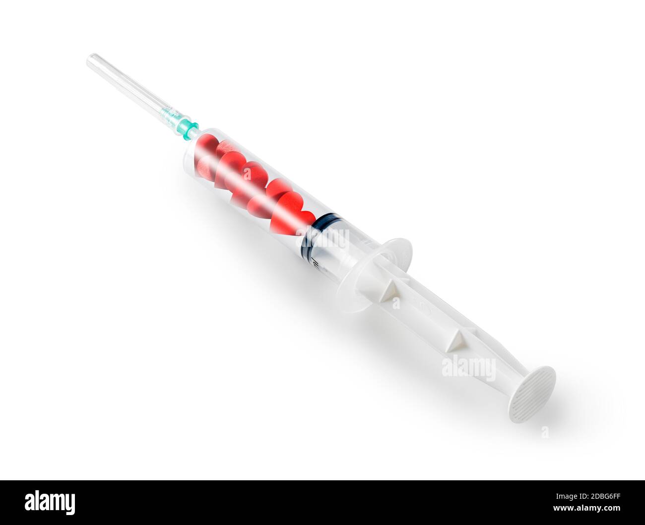 A clear syringe contains small red hearts to inject love as medicine. Stock Photo