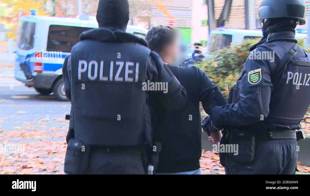 Berlin, Germany. 17th Nov, 2020. The freeze frame from a video shows police officers in Gitschiner Straße taking away a suspect in the case of the art theft in the Green Vault. Almost a year after the art theft in Dresden's Green Vault, police arrested three suspects this morning in Berlin. Credit: Fred Müller/dpa - ATTENTION: Person was pixelated for legal reasons/dpa/Alamy Live News Stock Photo
