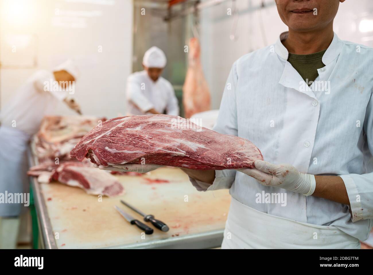 Premium wagyu beef in the process by the butcher in the slaughterhouse Stock Photo