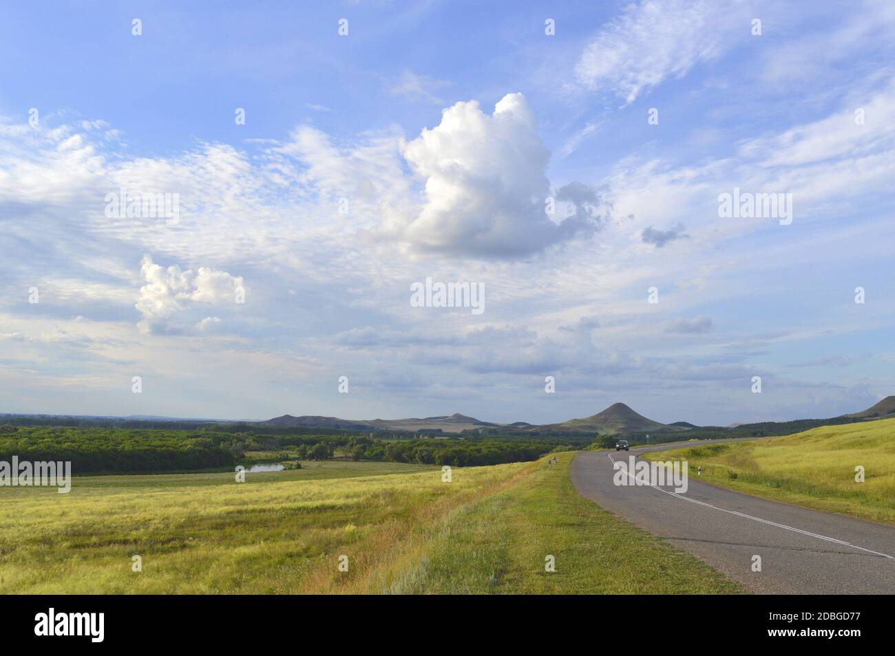summer landscape with road, mountain and blue sky with clouds Stock ...