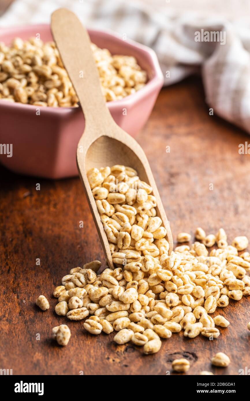 Puffed wheat covered with honey on wooden table. Stock Photo