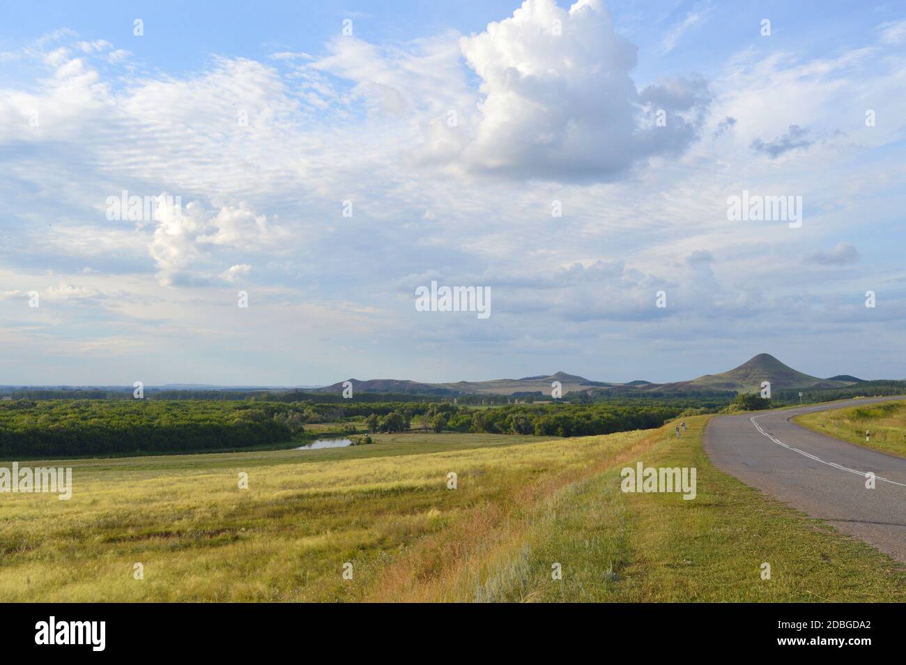 summer landscape with road, mountain and blue sky with clouds Stock ...