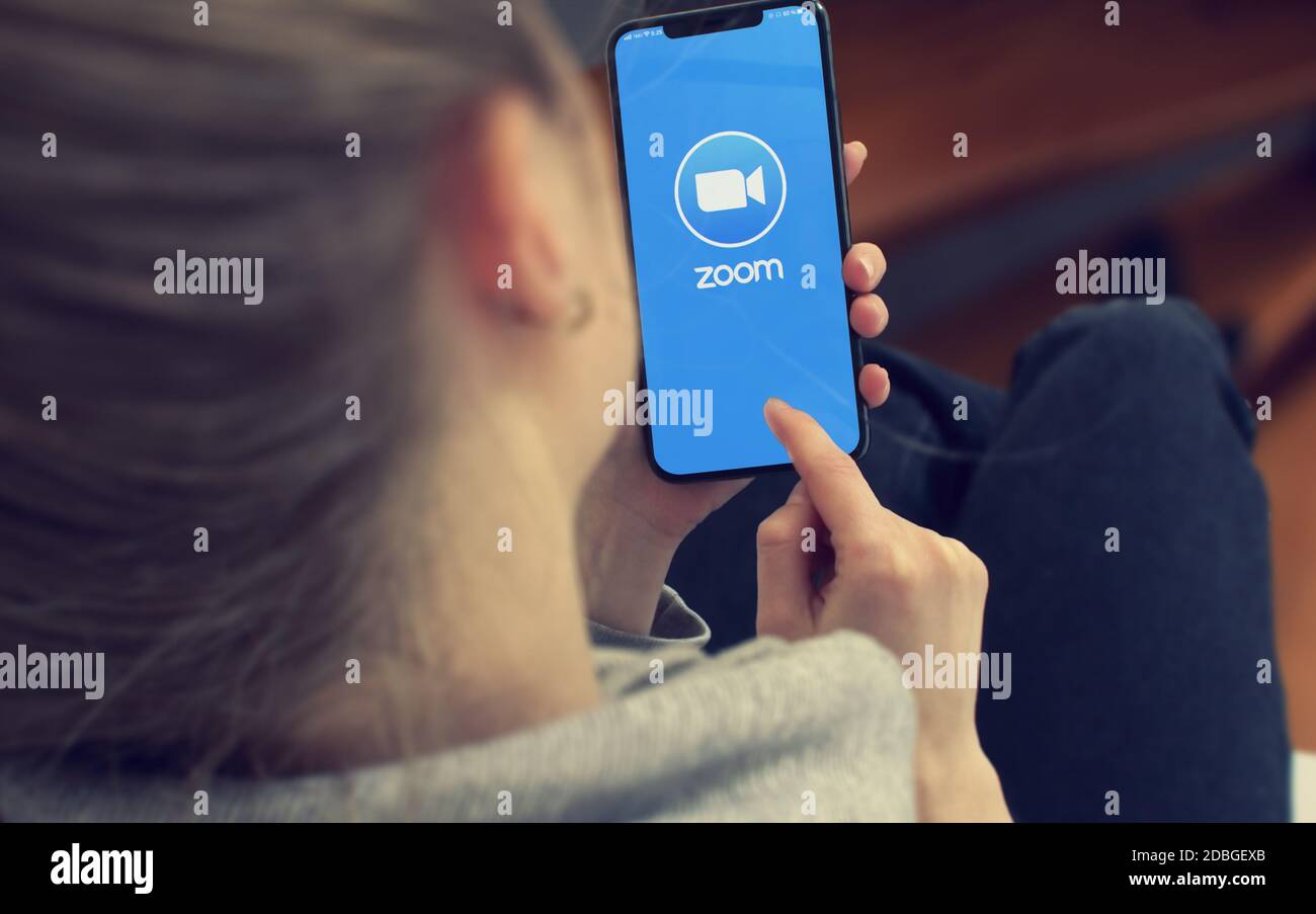KYIV, UKRAINE-JANUARY, 2020: Zoom on Cellphone Screen. Young Girl Pointing or Texting Smart Phone During a Pandemic Self-Isolation and Coronavirus Pre Stock Photo