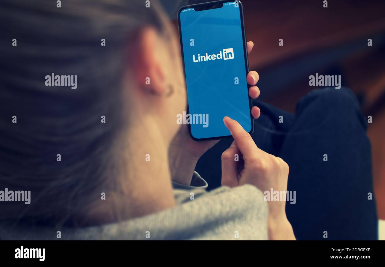 KYIV, UKRAINE-JANUARY, 2020: Linkedin on Smartphone Screen. Young Girl Pointing or Texting Smart Phone During a Pandemic Self-Isolation and Coronaviru Stock Photo
