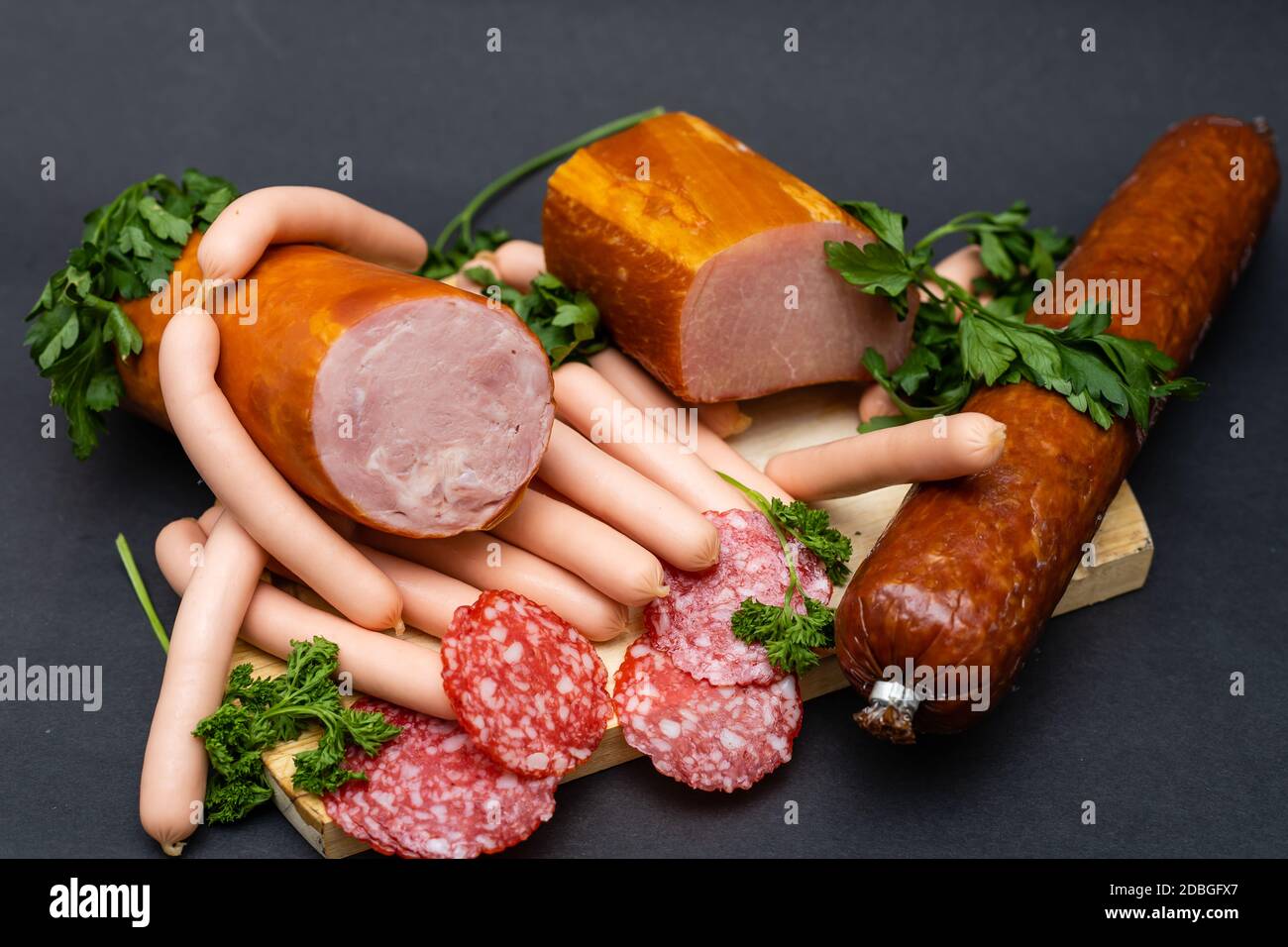 composition of cold cuts on wooden board with different type of cheese ...