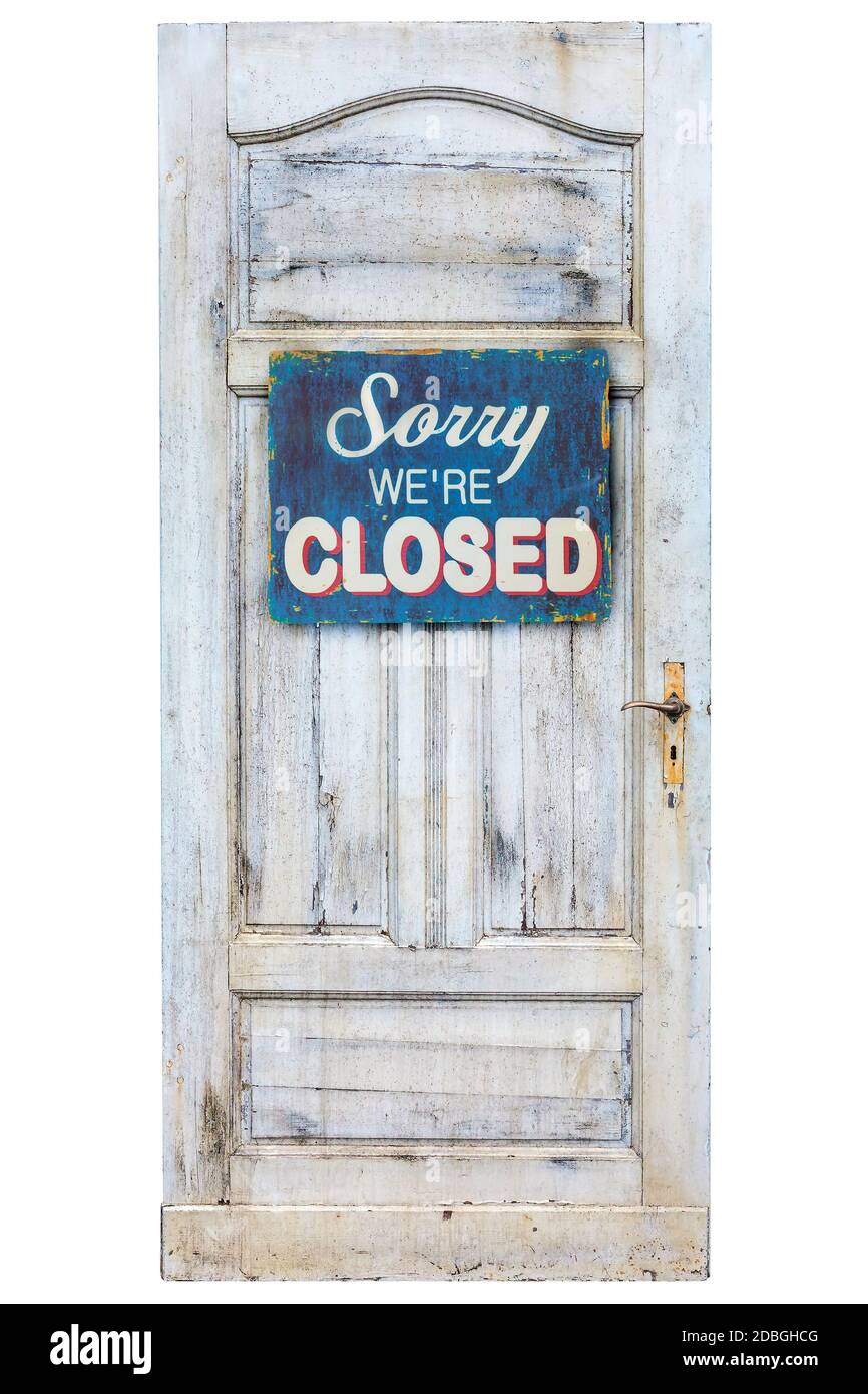 Weathered wooden door with sorry we are closed sign Stock Photo