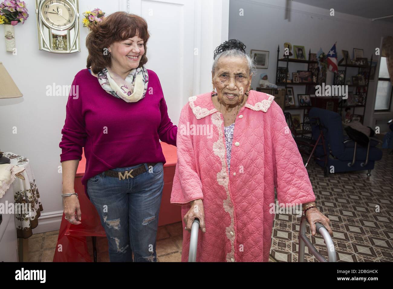 Portrait of a 0ne hundred and one year old woman with her social worker who checks on her regularly, at home in East Harlem, New York City. Stock Photo