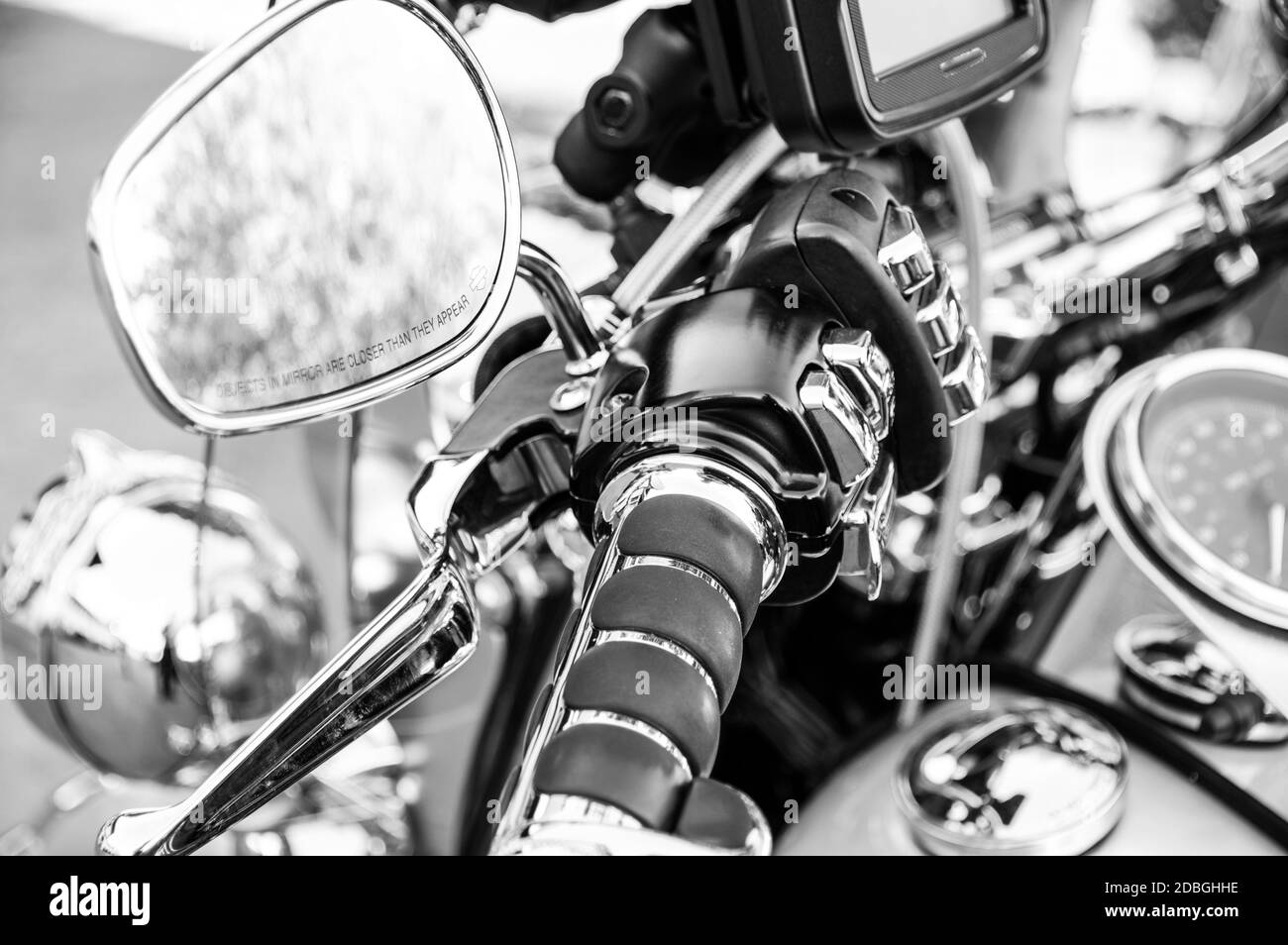 Motorcycle handlebar with rear-view mirror and buttons in black and white Stock Photo