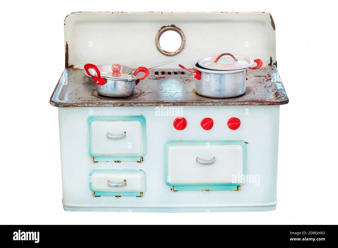 Vintage doll house cooking stove with pans isolated on a white background Stock Photo