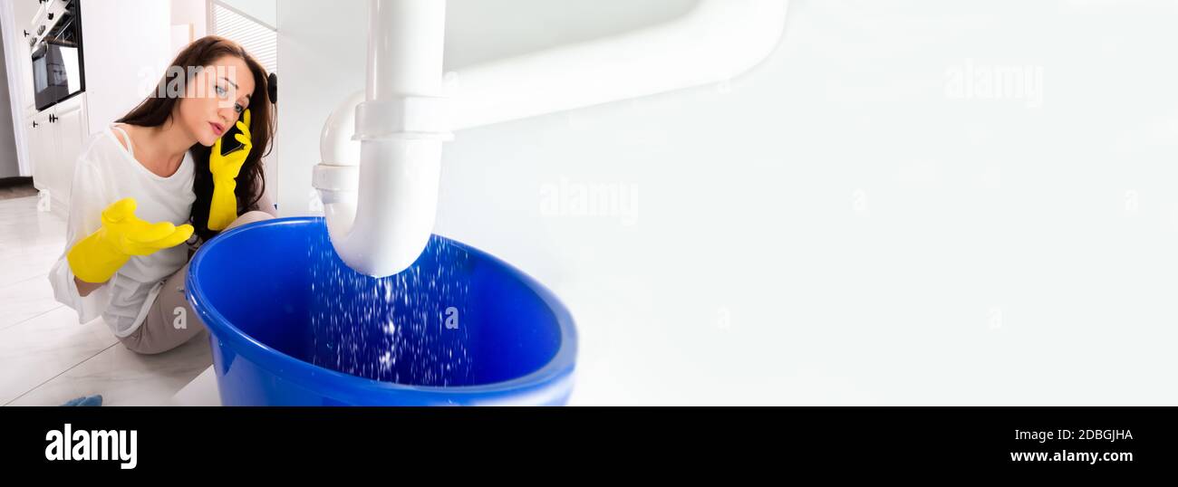 Calling Plumber In Kitchen Sink Pipe Leakage Stock Photo Alamy