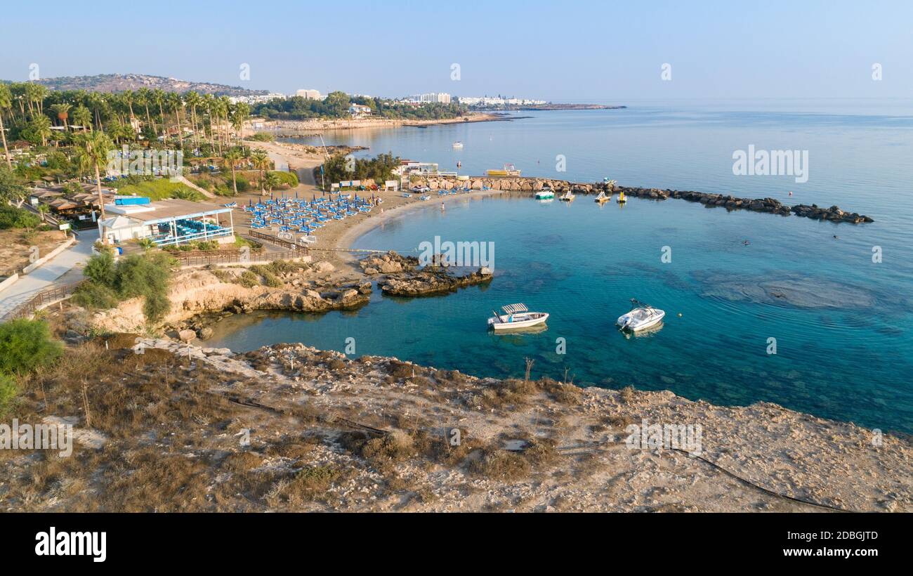 Aerial bird's eye view of Green bay in Protaras, Paralimni, Famagusta, Cyprus. The famous tourist attraction diving location rocky beach with boats, s Stock Photo