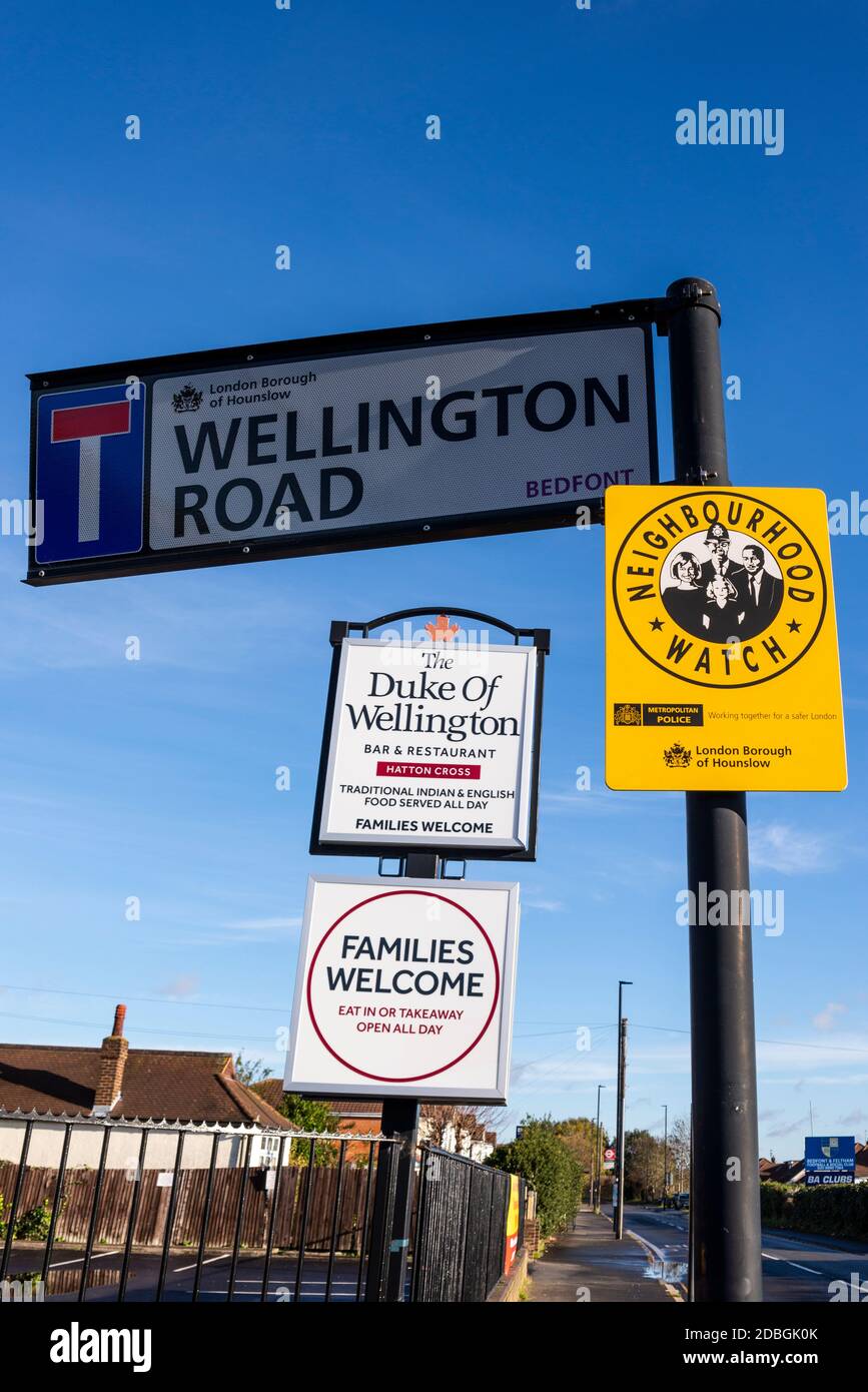 The Duke of Wellington pub in Wellington Road, Bedfont, Feltham near Heathrow Airport, London, UK. Neighbourhood watch warning sign Stock Photo