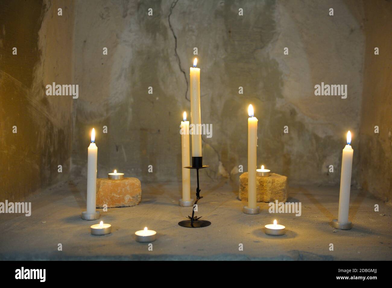 Candles burning against the wall Stock Photo Alamy