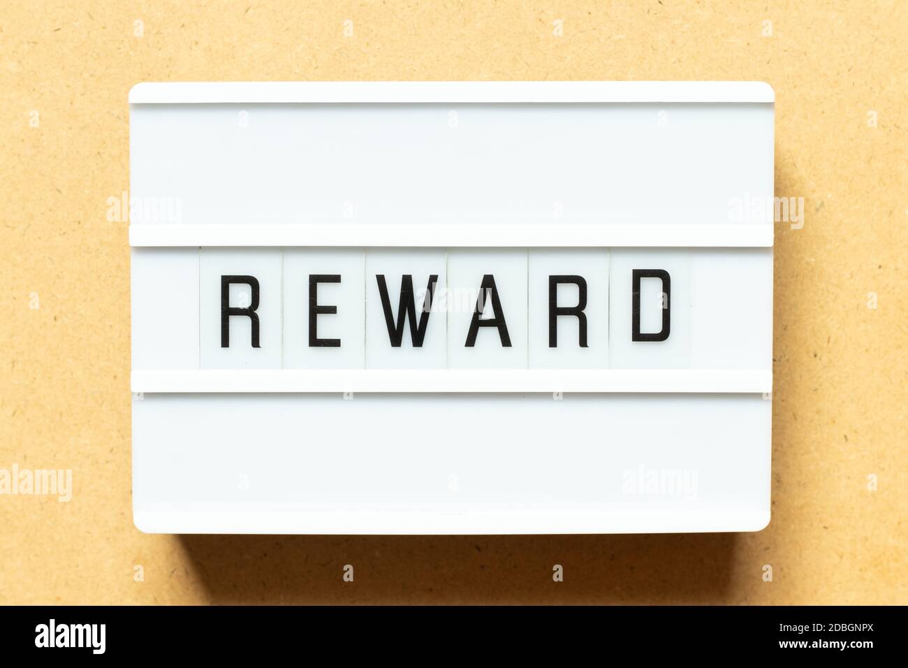 Lightbox with word reward on wood background Stock Photo