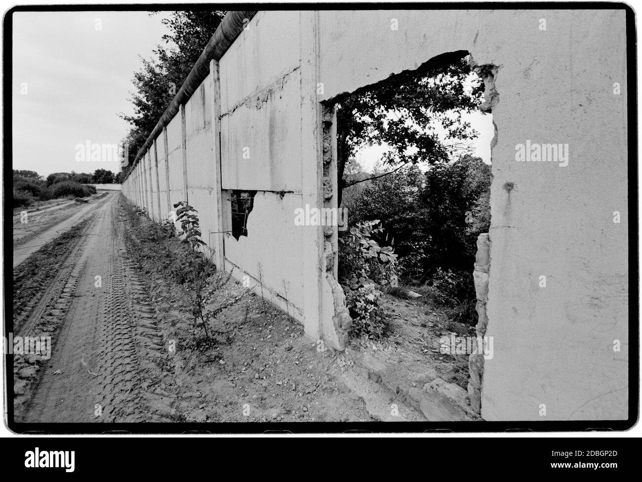 East Germany 1990 scanned in 2020 The remains of the Wall near Hanum on the border between former East and West Germany. Hanum is a village and a former municipality in the district Altmarkkreis Salzwedel, in Saxony-Anhalt, Germany. Since 1 January 2010, it has been a part of the municipality Jübar East Germany, Deutsche Demokratische Republik the DDR after the fall of the Wall but before reunification March 1990 and scanned in 2020.East Germany, officially the German Democratic Republic, was a country that existed from 1949 to 1990, the period when the eastern portion of Germany was part of t Stock Photo