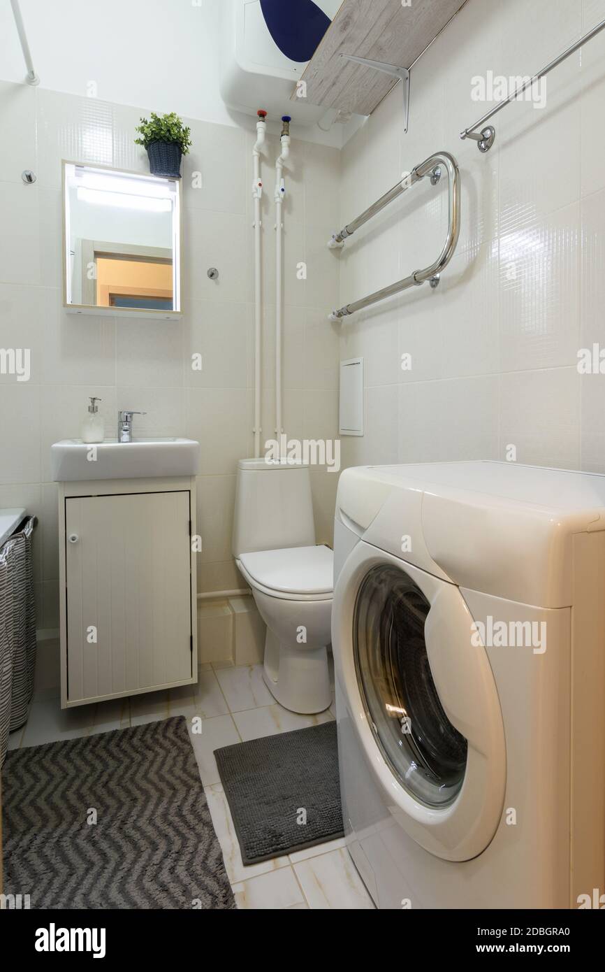 Classic small toilet with washing machine and washbasin Stock Photo Alamy