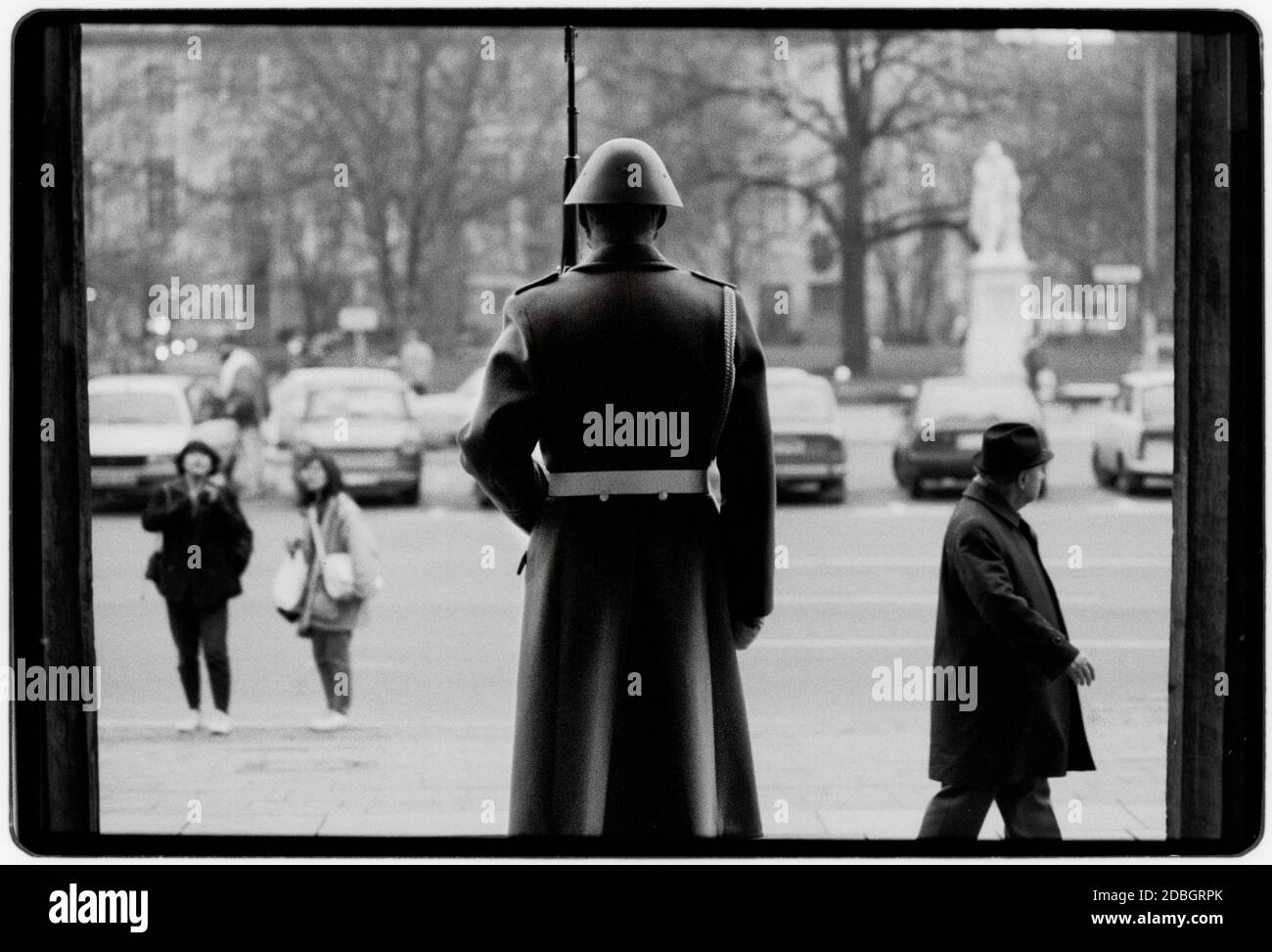 East Germany 1990 scanned in 2020 Neue Wache in Berlin. Two soldiers of the Friedrich Engels Guard Regiment in 1990. The Neue Wache (English: New Guardhouse) is a listed building on Unter den Linden boulevard in the historic centre of Berlin. Erected from 1816 to 1818 according to plans by Karl Friedrich Schinkel as a guardhouse for the Royal Palace and a memorial to the Liberation Wars, it is considered as a major work of Prussian Neoclassical architecture East Germany, Deutsche Demokratische Republik the DDR after the fall of the Wall but before reunification March 1990 and scanned in 2020.E Stock Photo