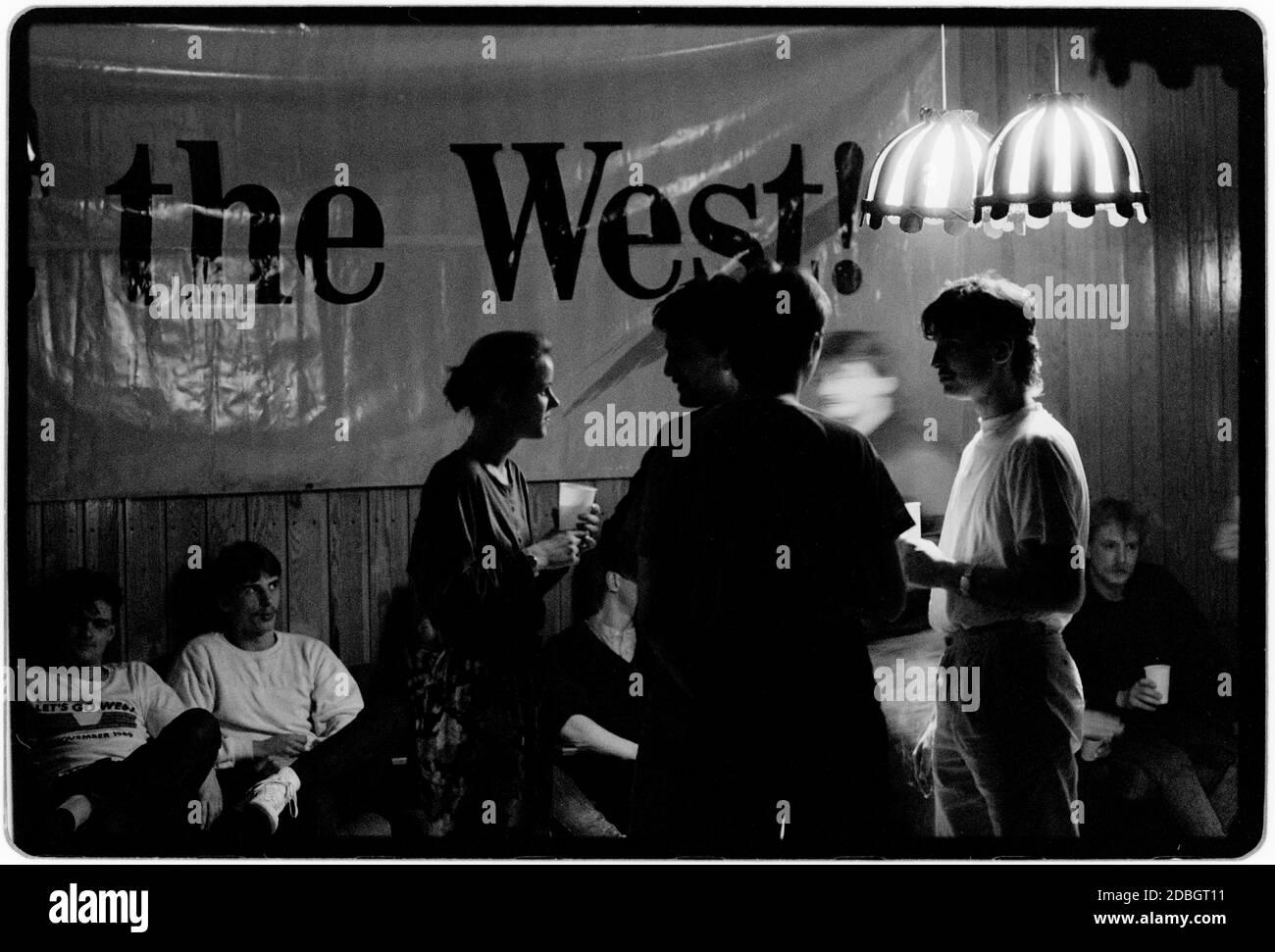 East Germany 1990 scanned in 2020 Rostock on the Baltic coast. Young people enjoy a dance at the Disco sponsered by West cigarettes in 1990 East Germany, Deutsche Demokratische Republik the DDR after the fall of the Wall but before reunification March 1990 and scanned in 2020.East Germany, officially the German Democratic Republic, was a country that existed from 1949 to 1990, the period when the eastern portion of Germany was part of the Eastern Bloc during the Cold War. Stock Photo