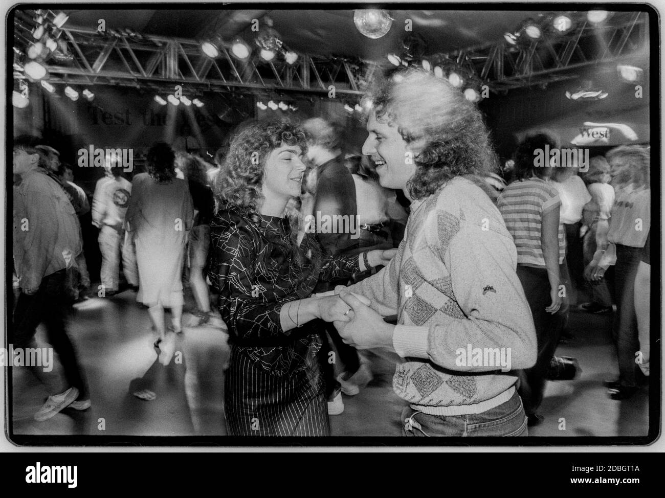 East Germany 1990 scanned in 2020 Rostock on the Baltic coast. Young people enjoy a dance at the Disco sponsered by West cigarettes in 1990 East Germany, Deutsche Demokratische Republik the DDR after the fall of the Wall but before reunification March 1990 and scanned in 2020.East Germany, officially the German Democratic Republic, was a country that existed from 1949 to 1990, the period when the eastern portion of Germany was part of the Eastern Bloc during the Cold War. Stock Photo