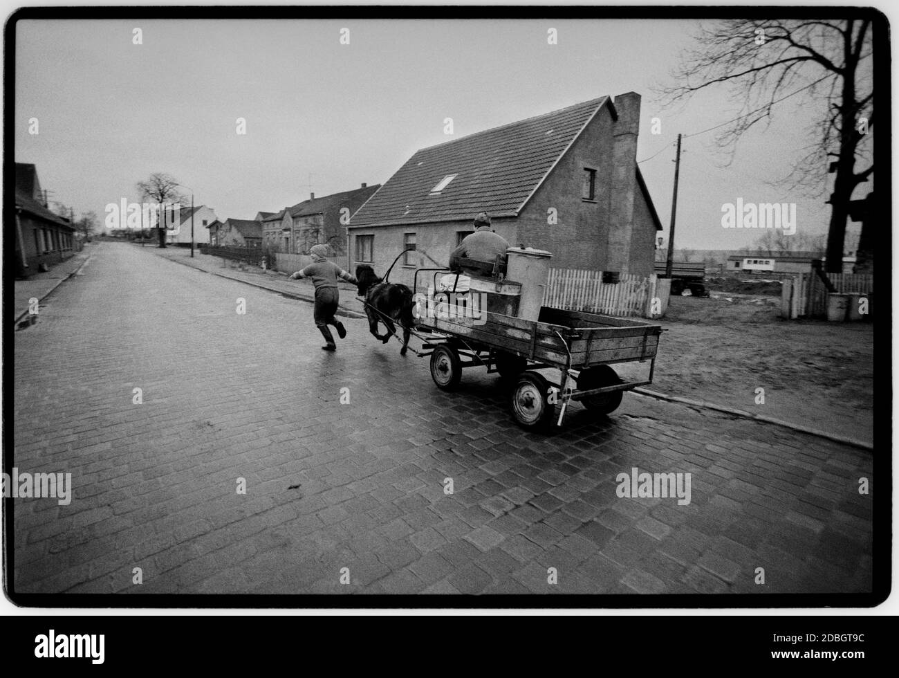 East Germany 1990 scanned in 2020 Street life in border village of Gladdenstedt. East Germany, Deutsche Demokratische Republik the DDR after the fall of the Wall but before reunification March 1990 and scanned in 2020.East Germany, officially the German Democratic Republic, was a country that existed from 1949 to 1990, the period when the eastern portion of Germany was part of the Eastern Bloc during the Cold War. Stock Photo