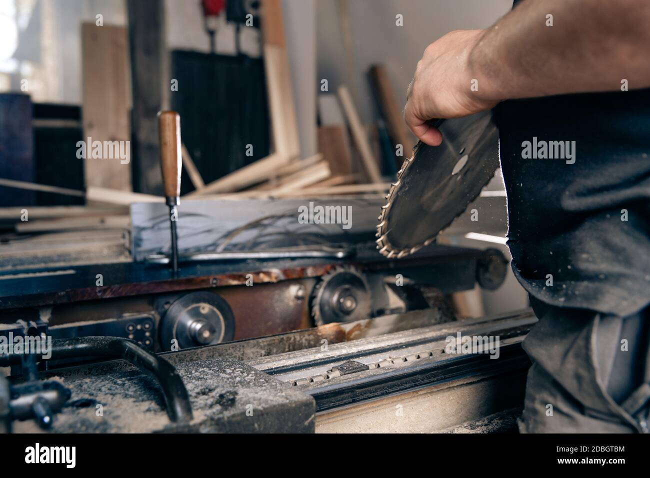 replacement of a gear cutting disc on a circular saw in a joinery. Stock Photo