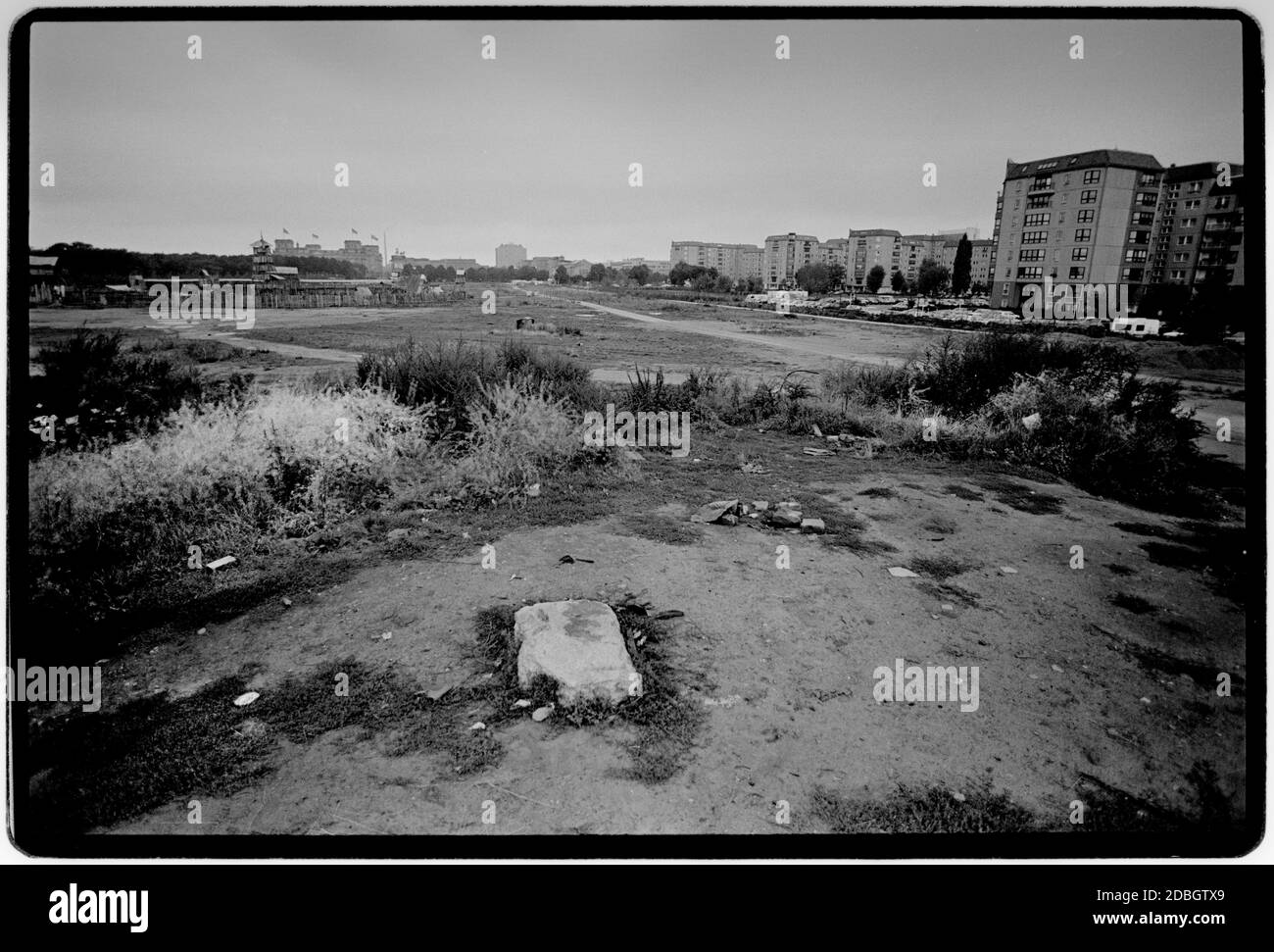 East Germany 1990 scanned in 2020 Potsdamer Platz, the former heavilly defended no mans land only 5 months earlier, in the centre of Berlin showing on the right in what was EAST Berlin apartments for high ranking east German officials. The white stone in the foreground marks the spot where Hitlers bunker is. East Germany, Deutsche Demokratische Republik the DDR after the fall of the Wall but before reunification March 1990 and scanned in 2020.East Germany, officially the German Democratic Republic, was a country that existed from 1949 to 1990, the period when the eastern portion of Germany was Stock Photo
